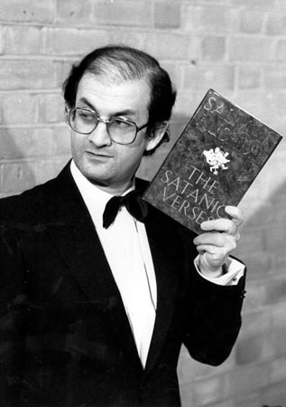 Salman Rushdie holding a copy of his book The Satanic Verses