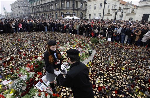 Volunteers carry candles in front of the Presidential Palace in Warsaw, Poland, Sunday, April 11, 2010, after Polish President Lech Kaczynski died in a plane crash. Kaczynski, his wife and some of the country's highest military and civilian leaders died on Saturday April, 10, 2010, when the presidential plane crashed as it attempted to land in thick fog in western Russia, killing 96. (AP Photo/Petr David Josek) 
