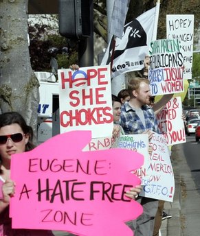 Protestors hold signs outside the hotel where Sarah Palin, former vice presidential candidate and Alaskan governor,  is scheduled to speak to a gathering of Lane County Republicans in Eugene, Ore. on Friday, April 23, 2010. (AP Photo/Don Ryan)