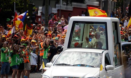 Pope Benedict XVI arrives to huge crowds of young people in Madrid. Photograph: Pedro Armestre/AFP/Getty Images 