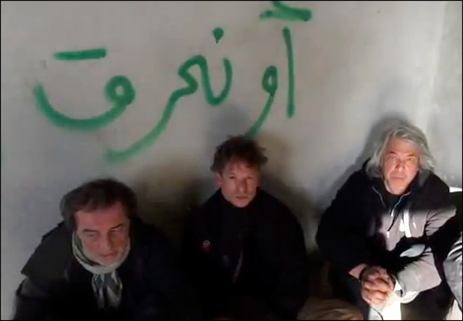 This image taken from undated amateur video posted on the Internet shows NBC chief foreign correspondent Richard Engel, center, with NBC Turkey reporter Aziz Akyavas, left, and NBC photographer John Kooistra, right, after they were taken hostage in Syria. (AP Photo/Amateur Video) 