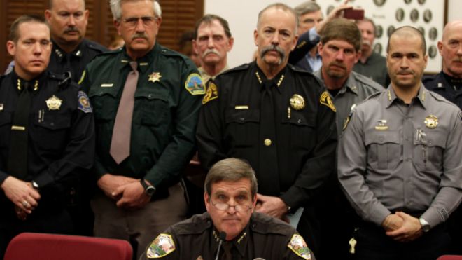 March 4, 2013: Weld County Sheriff John Cooke, center, backed by a group of fellow sheriffs, testifies against proposed gun control legislation in the Colorado Legislature, at the State Capitol, in Denver. (AP)