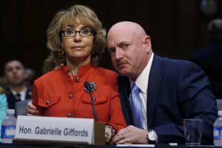 Former U.S. Rep. Gabrielle Giffords (L) delivers her opening remarks while seated next to her husband, former U.S. Navy Captain Mark Kelly, during a hearing held by the Senate Judiciary committee about guns and violence on Capitol Hill in Washington, January 30, 2013. REUTERS/Larry Downing