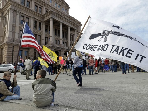 Gun rights supporters gather at a Guns Across America rally at the Texas state capitol, Saturday, Jan. 19, 2013, in Austin, Texas. Thousands of gun advocates have gathered peacefully at state capitals across the U.S. to rally against stricter limits on firearms. (AP Photo/Eric Gay)