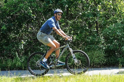 WEST TISBURY , MA - AUGUST 16: U.S. President Barack Obama rides a bike during a vacation on Martha's Vineyard August 16, 2013in West Tisbury, Massachusetts. Obama and his family are on a weeklong vacation.  (Photo by Rick Friedman-Pool/Getty Images)