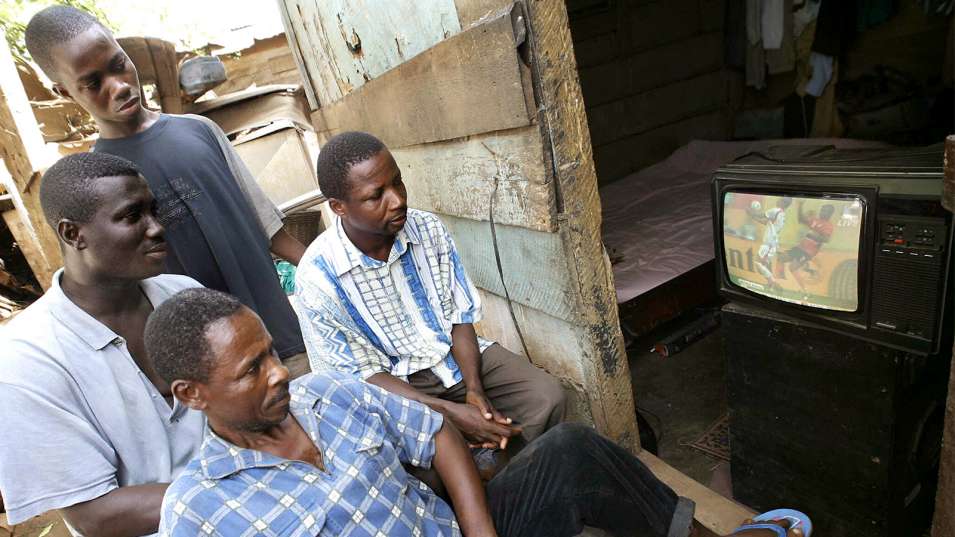 Ghanaians watch the World Cup in 2006 in their room in a poor area of Accra. KAMBOU SIA / AFP