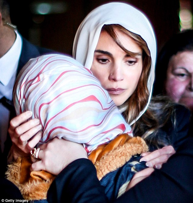 Heart-wrenching: Queen Raina of Jordan comforts Anwar Tarawneh, wife of the pilot who was brutally murdered at the hands of ISIS militants, at her late husband's ancestral home near the southern town of Karak