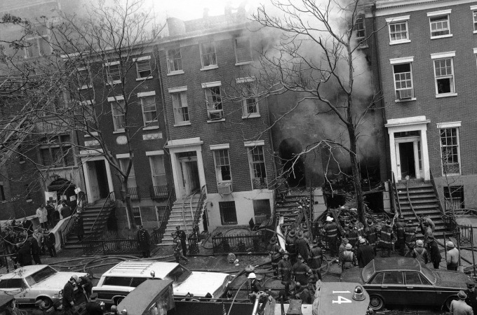 Firefighters work at extinguishing the fire at a residence at 18 West 11th Street in the Greenwich Village section of New York, March 6, 1970, which was rocked by three explosions at midday. The first blast touched off the fire just before noon and two more explosions occurred after the arrival of firefighters at the two-alarm blaze in the four-story townhouse. (AP Photo/Marty Lederhandler)   Weatherman bombing.